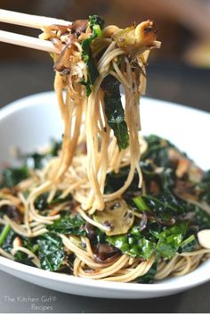 a white bowl filled with noodles and vegetables