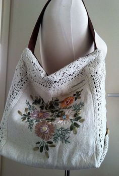 a white purse with flowers and leaves on it