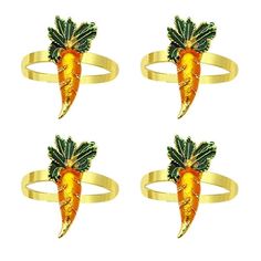 four rings with carrots on them are shown in three different colors and sizes, one is gold