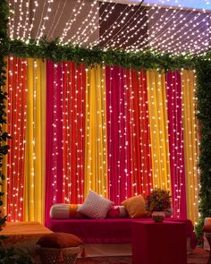 an outdoor stage decorated with bright lights and decorations for a wedding or special event in the evening