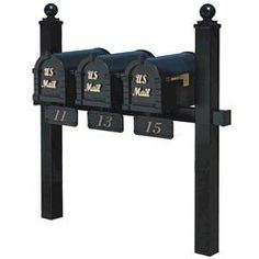 three mailboxes are attached to a black post