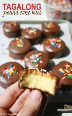 a hand holding up a half eaten chocolate cake bites