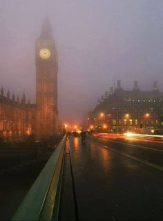 the big ben clock tower towering over the city of london on a foggy night