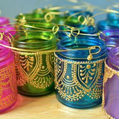 colorful jars are lined up on a table