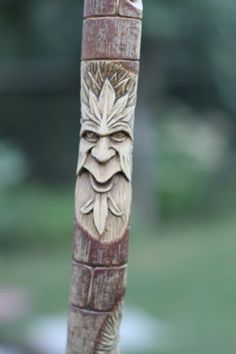 a carved wooden pole with a face on it