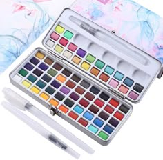 the watercolor paint set is open and ready to be filled with it's contents