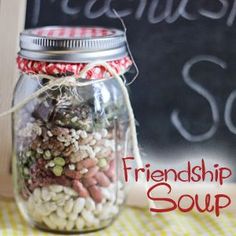 a jar filled with lots of different types of food sitting on top of a table