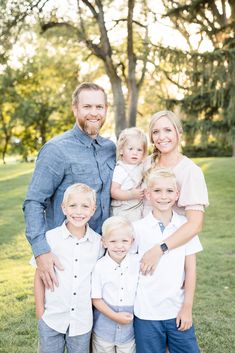 a family posing for a photo in the park