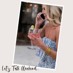 a woman talking on her cell phone while holding a wine glass with a lime in it