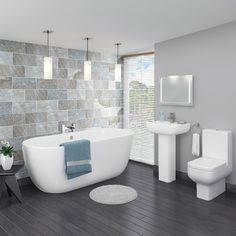 a white bath tub sitting next to a toilet in a bathroom