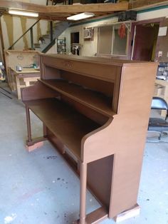 an old piano is being worked on in a shop