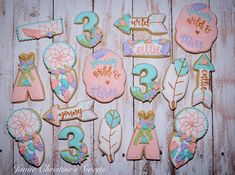 decorated cookies are arranged on a wooden table with the numbers 3, 4, 5 and 6