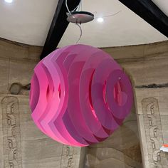 a large pink sculpture hanging from the ceiling