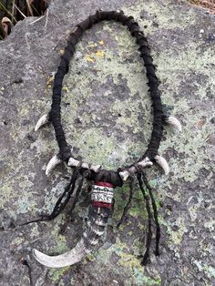 Step into the mystical world of shamanic rituals with our Shaman Necklace. This exquisite piece is crafted for those seeking to embrace their inner spiritual journey. Magnificently detailed and adorned with plastic goat horn and fake bones, this necklace is the perfect accessory for any shaman costume or fantasy-themed event. Ideal for horror lovers, LARP enthusiasts, or those attending ConQuest of Mythodea, this post-apocalyptic inspired jewelry exudes an aura of ancient wisdom and mysticism. G Spiritual Halloween Festival Necklaces, Spiritual Necklaces For Halloween Festival, Spiritual Necklace For Halloween Festival, Shaman Costume, Shaman Necklace, Apocalypse Costume, Goat Horns, Horror Lovers, Gift Post