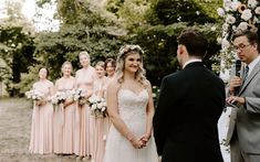 a bride and groom are getting married in front of the bridal party at their wedding