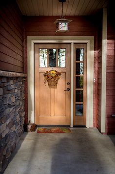 a front door with a basket full of flowers on it