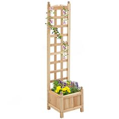 a wooden planter with flowers in it