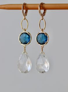 Elegant Earrings with Faceted Clear Crystal Pear Drops 17 x 12 mm Faceted Blue Sapphire Glass Stones in Gold Plated Bezel setting 12 x 12 mm Gold plated Lever back Round Ear clasp. The total length is 2.3 inches or 58 mm * *.* * * * * * * * * * * * * * * * * * * * * * * * * * * * Your order will be wrapped and shipped in jewelry gift box. Please enter my shop here - www.etsy.com/shop/ZarinaJewelry or my FB page - facebook.com/ZarinaJewelry Faceted Drop Earrings For Wedding, White Faceted Earrings For Wedding, Briolette Faceted Wedding Earrings, Wedding Briolette Faceted Earrings, Wedding White Faceted Earrings, Teardrop Faceted Earrings For Wedding, Faceted Teardrop Earrings For Weddings, Blue Briolette Earrings For Wedding, Wedding Teardrop Faceted Earrings