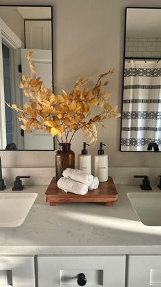 a bathroom with two sinks and a wooden cutting board on the counter top next to it