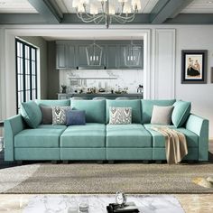 a living room filled with furniture and a chandelier