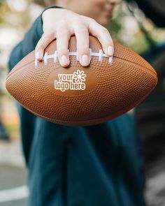 a close up of a person holding a football