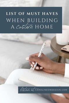 a person writing on a notebook with the words list of must haves when building a certain home