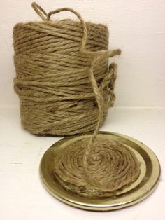 two spools of twine sitting next to each other on a metal plate