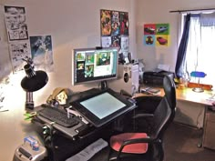 a desk with a computer, keyboard and mouse on it in front of a window