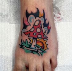 a foot with a mushroom tattoo on it