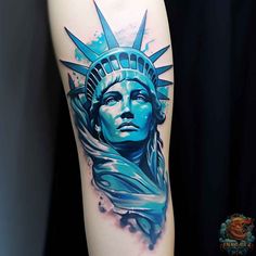 the statue of liberty tattoo is shown with blue ink and watercolors on it