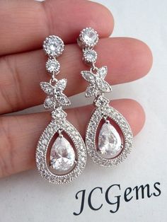 This earring features a high quality white clear halo pear shaped cubic zirconia Frame with a cubic zirconia hanging in the middle,  with multi fancy cubic zirconias with a round posted cubic zirconia earrings.Size: about 40 mm, or 1.6 inches long.**NOTE: CUBIC ZIRCONIA HAS MANY DIFFERENT GRADES, AND ALL THE CUBIC ZIRCONIA USED IN MY DESIGN IS OF THE HIGHTEST QUALITY. IT SPARKS LIKE DIAMOND AND MUCH PRETTIER IN PERSON) **Express Shipping available, delivery in about 3 business days , please cont Sparkling Pear-shaped Cubic Zirconia Bridal Earrings, Pear-shaped Diamond White Cubic Zirconia Bridal Earrings, White Cubic Zirconia Teardrop Earrings With Sparkling Stones, White Teardrop Earrings With Sparkling Cubic Zirconia, Pear-shaped Cubic Zirconia Bridal Earrings, Bridal Teardrop Earrings With Halo Design In Cubic Zirconia, Bridal Teardrop Halo Earrings In Cubic Zirconia, Bridal Teardrop Cubic Zirconia Earrings With Halo Design, Cubic Zirconia Teardrop Bridal Earrings With Halo Design