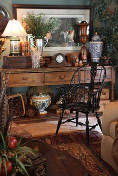 a living room filled with furniture and lots of plants on top of a wooden table