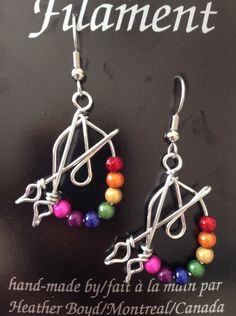 These earrings are a great gift for artists and art teachers. Beads are called Miracle Beads. Wire is non-tarnish aluminum. Surgical steel earring hooks are hypo-allergenic. I have been making custom wire art and jewelry for 30 years. I started in 1989 selling jewelry on the streets of Montreal. Over the years I have participated in many craft shows, exhibitions and sold my work in gallery shops across Canada including the National Gallery of Canada. My husband and I specialize in custom wedding Artsy Nickel-free Dangle Hoop Earrings, Artsy Adjustable Nickel-free Beaded Earrings, Adjustable Nickel-free Beaded Artsy Earrings, Adjustable Nickel-free Artsy Beaded Earrings, Artsy Nickel-free Hoop Earrings As Gift, Artsy Earrings With Round Beads And Ear Wire, Adjustable Artsy Nickel-free Hoop Earrings, Adjustable Silver Plated Hoop Earrings As Gift, Artsy Wire Wrapped Earrings Gift