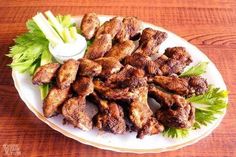 chicken wings with lettuce and ranch dressing on a white plate