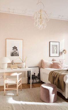 a bedroom with pink walls and white furniture