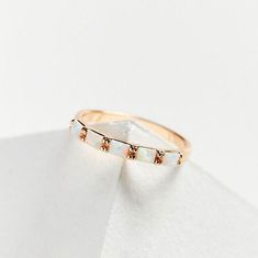 Experience the subtle sparkle and delicate beauty of our Opal Baguette Band. Made with precision-cut opal baguette stones, this stacking ring adds a touch of etheral glow to your ring stack. 14k gold plated brass 5 lab created opals 3 mm wide Questions about Shipping & Returns? Baguette Opal Ring, Opal Baguette Ring, Stackable 14k Gold Opal Ring, Adjustable Gold Opal Ring Fine Jewelry, Stackable Opal Ring For Anniversary, Fine Jewelry, Tarnish-resistant Yellow Gold Opal Jewelry, Elizabeth Stone, Baguette Band, Bag Icon