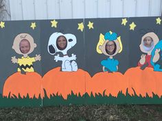 three children's pictures painted on the side of a fence with pumpkins and stars