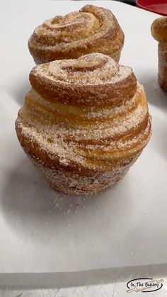 two pastries sitting on top of a white table