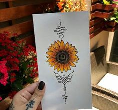 a person holding up a card with a sunflower on it