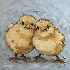 two little chicks are standing next to each other