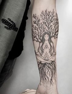 a person with a tree tattoo on their arm