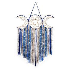 a blue and white dream catcher hanging on a wall