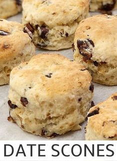 some biscuits that are sitting on top of a piece of paper with the words date scones