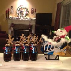 christmas decorations and wine bottles on a mantle