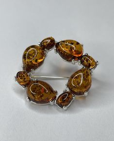 Beautiful Baltic Amber Stone Brooch with Sterling Silver 925. Product Details: Weight : 4.7 g Stone Color : Cognac Metal : Sterling Silver 925 Size : 30 mm x 30 mm  Ships from Small business in Baltic region !!! Items are shipped by Registered mail with Tracking Number only. If You have any Questions About Delivery time - Please, Contact us Directly, it depends on Destination Country. About Amber Stones: Based purely on how it is formed, amber is perhaps one of the most interesting gemstones of all. The stone is not only used in jewellery, it’s also used in a number of different decorative objects and has been popular for hundreds of years. Plus, it’s used as a healing agent in ancient folk medicine. While it’s found all over the world, certain amber stones are occasionally thought of as b Silver Amber Jewelry, Handmade Amber Jewelry Collectible, Elegant Sterling Silver Amber Jewelry, Unique Amber Sterling Silver Jewelry, Folk Medicine, Amber Brooch, Baltic Region, Natural Amber, Amber Stone