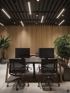 an empty conference table with two computers on it