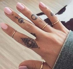 a woman's hand with two tattoos on it