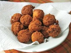 a plate full of fried food sitting on top of a tablecloth covered table cloth