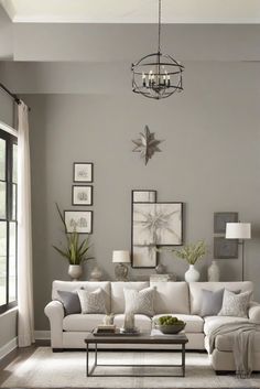 a living room with gray walls and white furniture