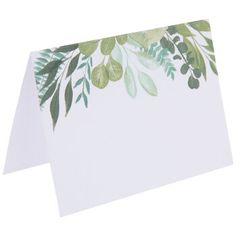 a white card with green leaves on it and a blank piece of paper in the middle